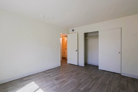 A room with a wooden floor and white walls.