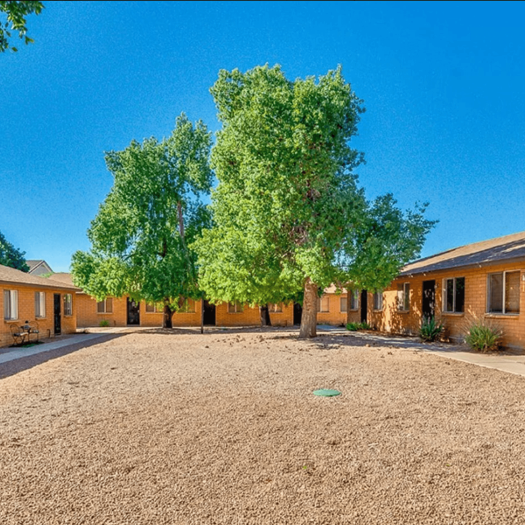 a large yard with trees in front of a house