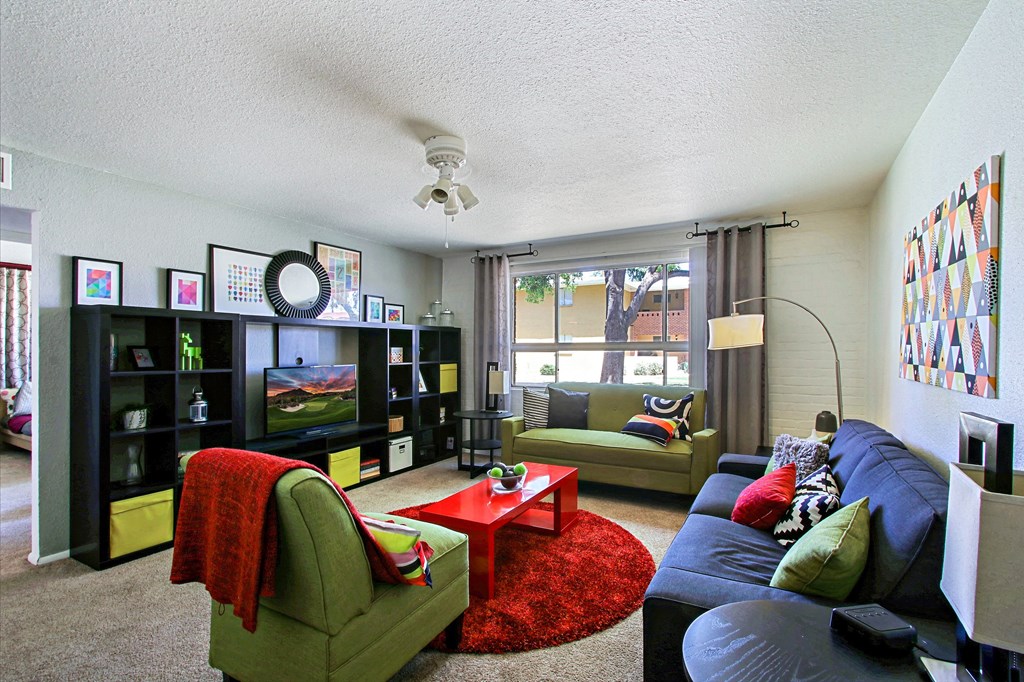 a living room filled with furniture and a large window