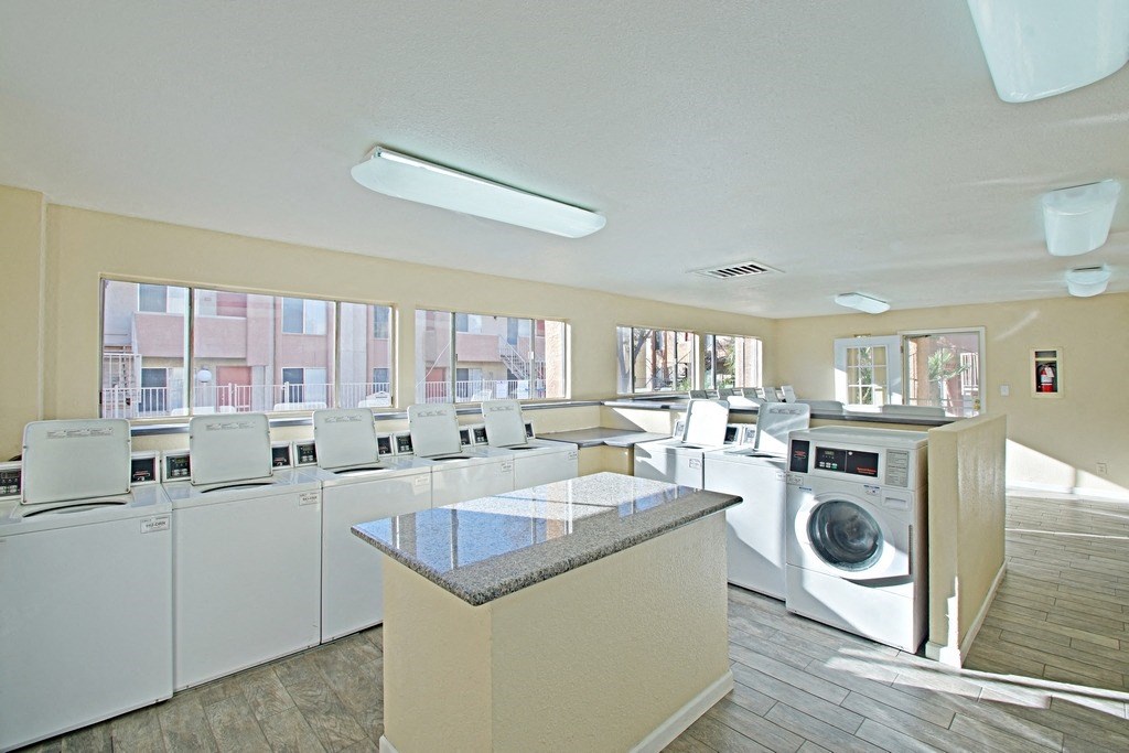 a laundry room with washers and dryers