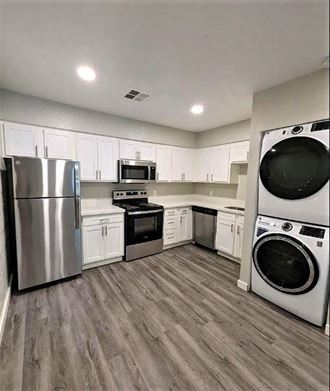 a kitchen with a stove top oven next to a refrigerator