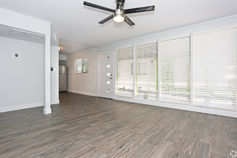 A room with a ceiling fan and wooden flooring. A room with a ceiling fan and wooden flooring. at Palm Villas, Scottsdale, 85257
