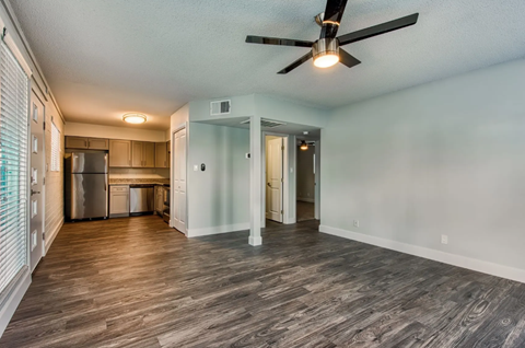 A room with a ceiling fan and wooden flooring. A room with a ceiling fan and wooden flooring. at Palm Villas, Arizona