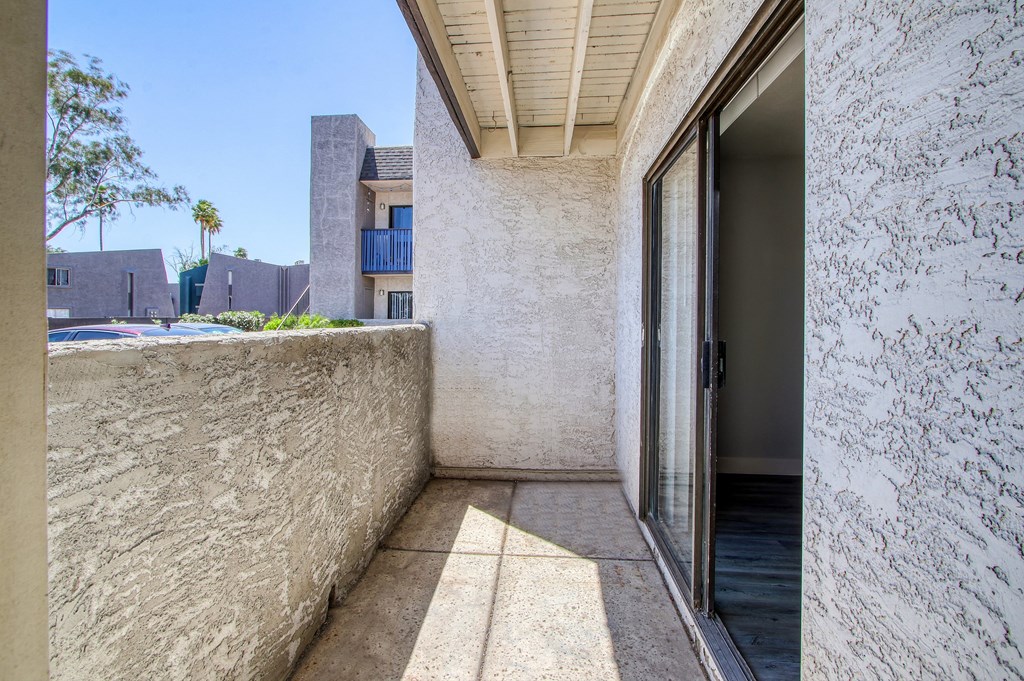 a patio with a door and a wall and a pool