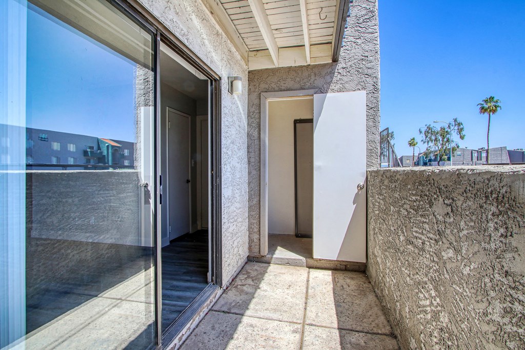 a view of a balcony with a door and a glass door