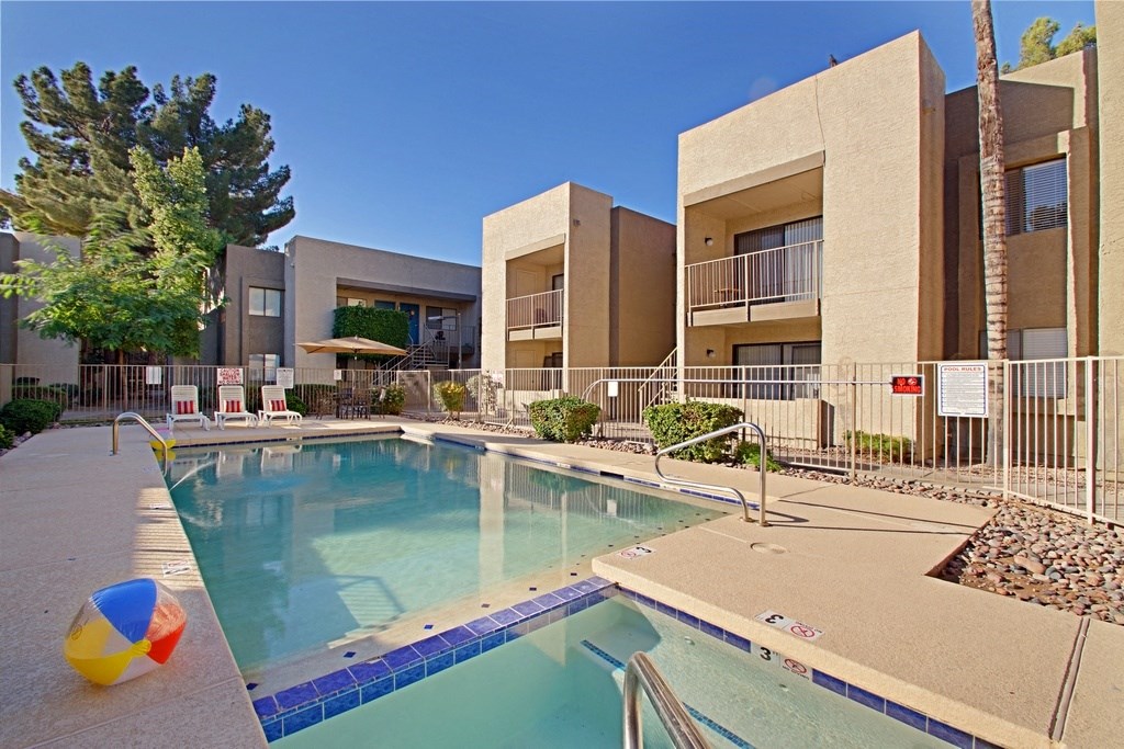 a swimming pool with a beach ball in front of a building