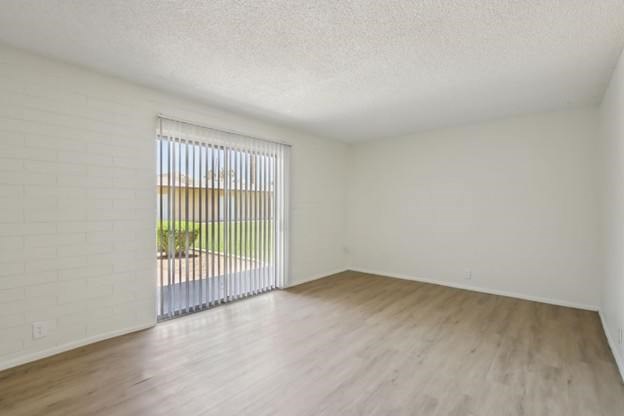 A room with a window and wooden flooring.
