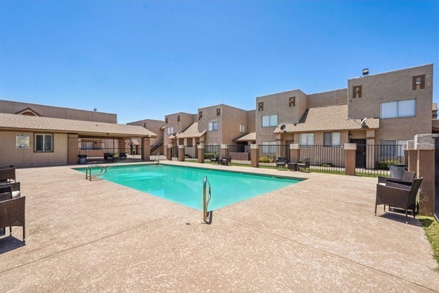 A swimming pool in a courtyard surrounded by buildings.