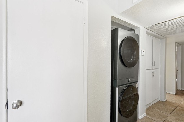 A washing machine is built into a wall in a laundry room.