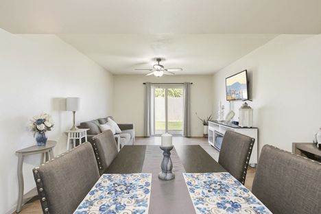 A dining room with a table set for six.