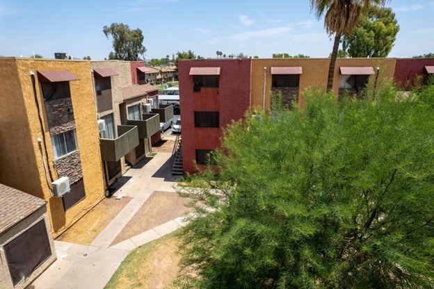 A view of a courtyard surrounded by buildings with trees.