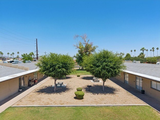A sunny day at a residential complex with a clear blue sky.