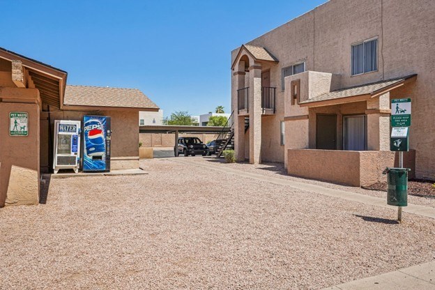 A Pepsi vending machine is outside a building.