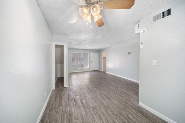 A room with a white ceiling and wooden flooring.