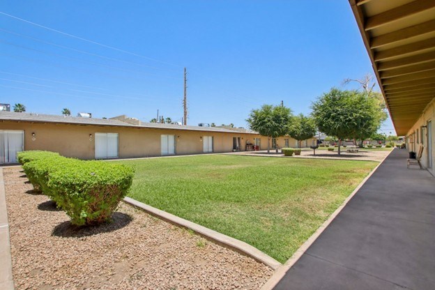 A sunny day at a residential complex with a clear blue sky.
