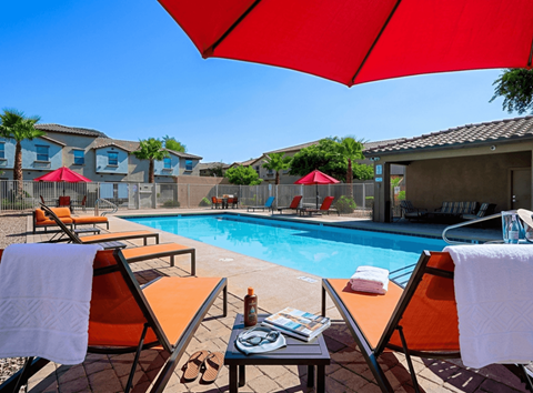 A poolside area with chairs and umbrellas.