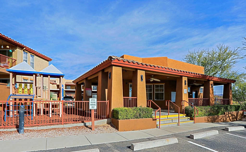 A building with a red roof and a blue awning is in the image.