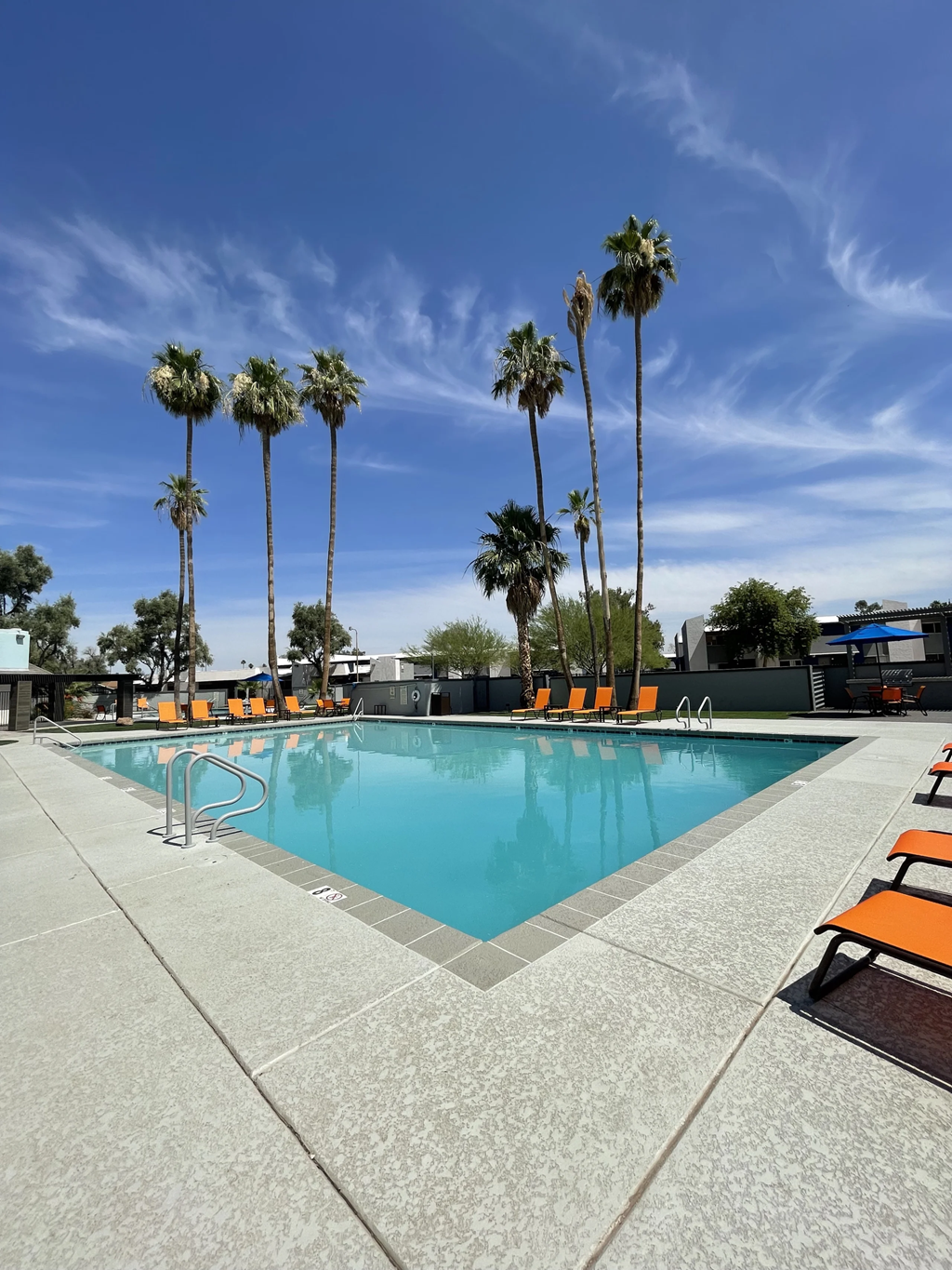 a swimming pool with palm trees in the background