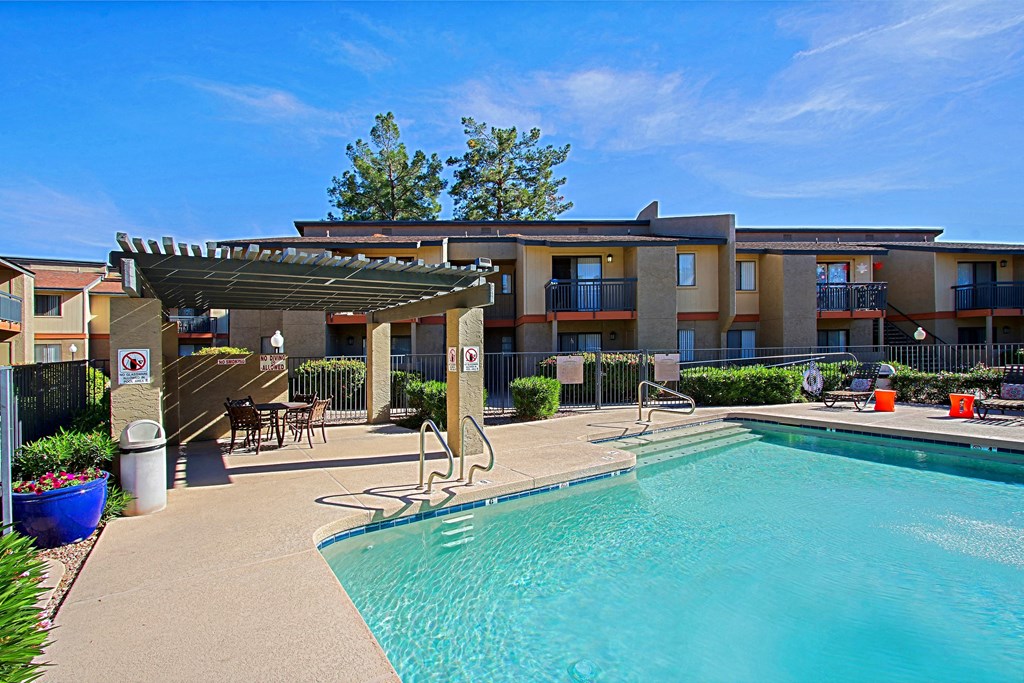 our apartments have a swimming pool and a patio with chairs
