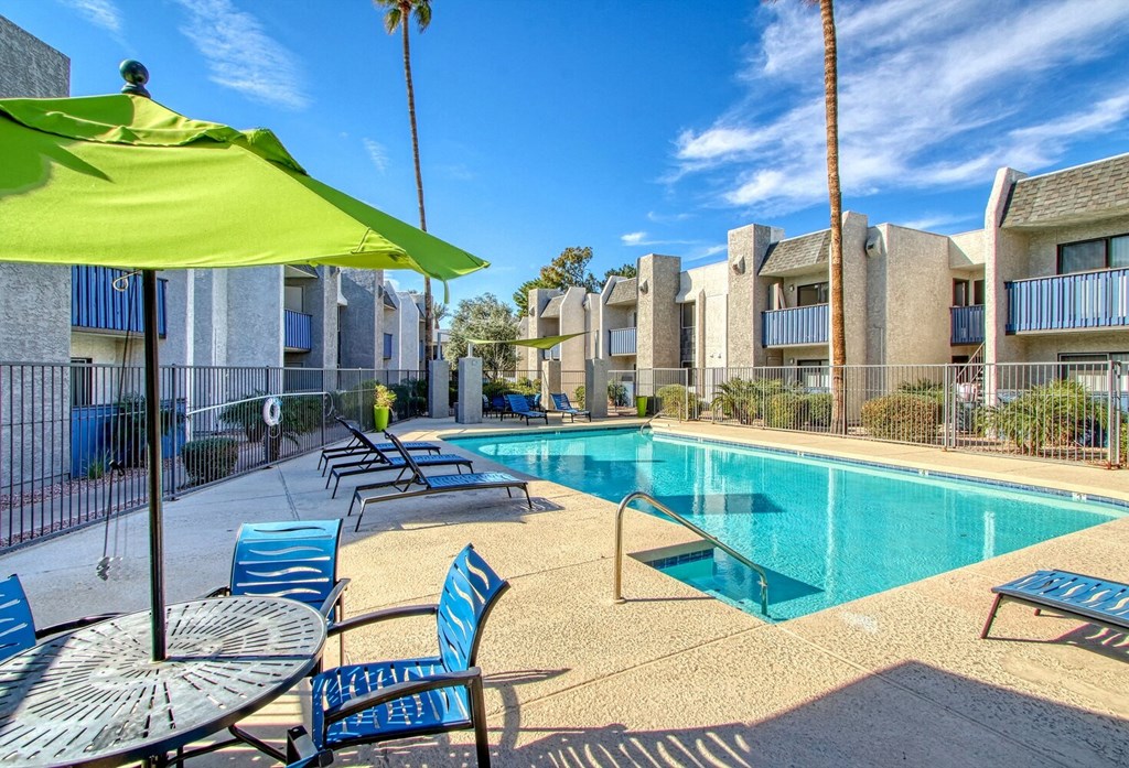 our apartments offer a swimming pool with chairs and an umbrella