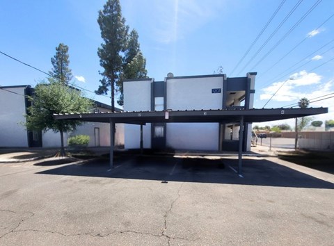 A parking lot with a building in the background.