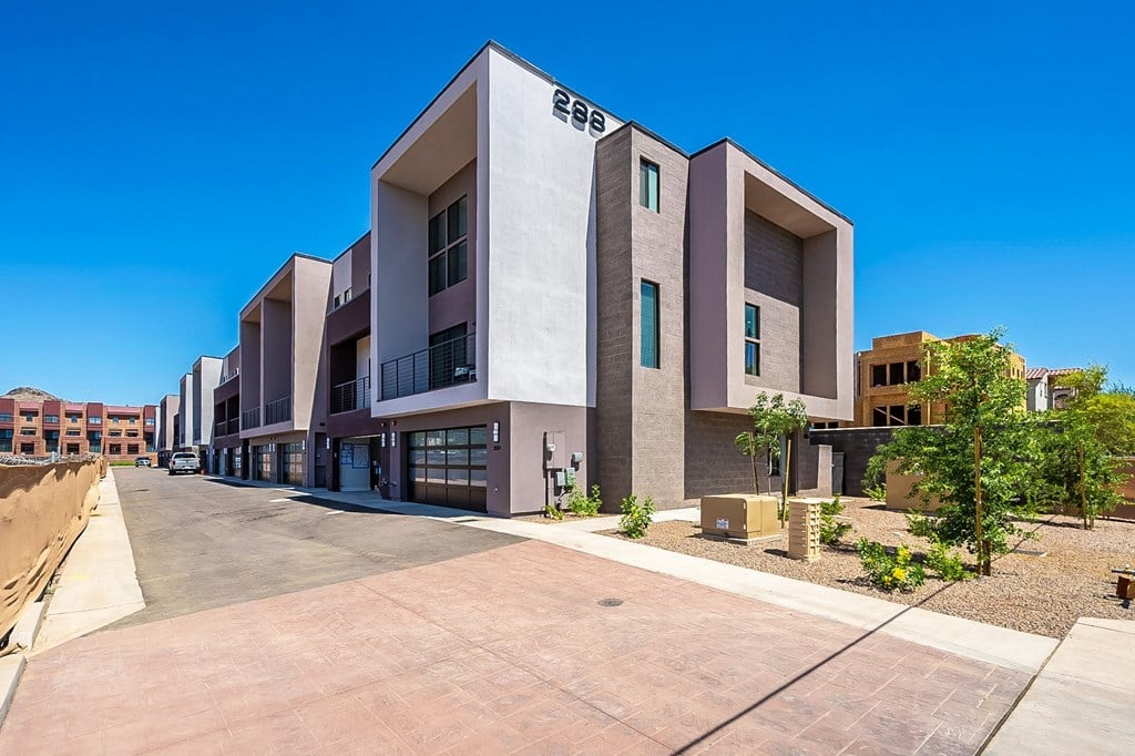 a building with a sidewalk and a street in front of it