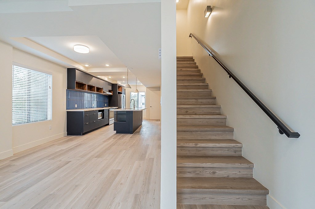 a view of a living room and a staircase with wood floors