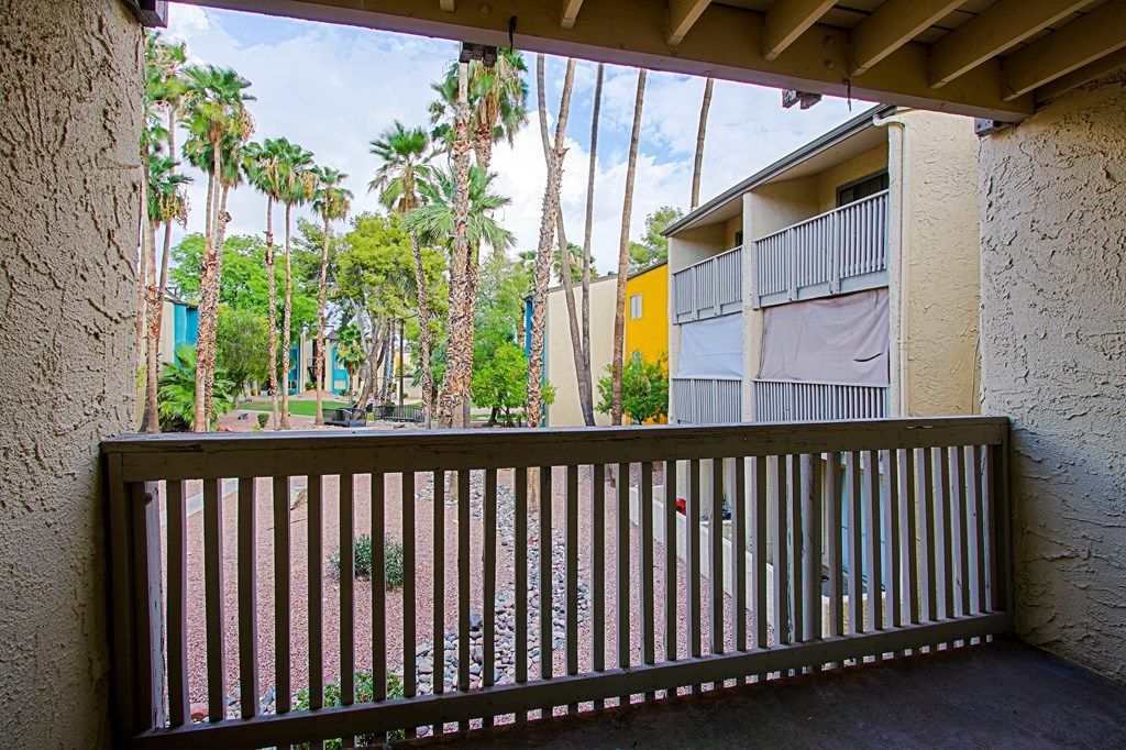 a balcony or terrace with a view of palm trees