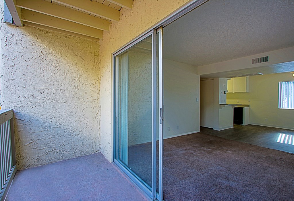 an empty living room with a sliding glass door