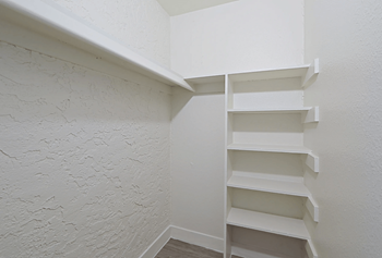 walk-in closet with white walls and built-in shelves at Allora Phoenix in Phoenix, AZ