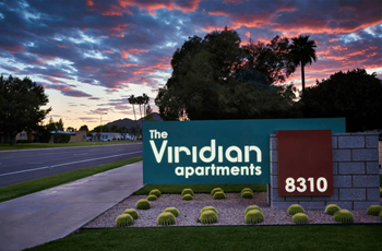 Sign for The Viridian Apartments at Dusk with Manicured Landscaping at The Viridian Apartments in Scottsdale, 85250