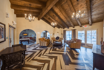 Clubhouse with Multicolored Wood Flooring Arrainged in a Herringbone Pattern at The Viridian Apartments in Scottsdale, Arizona 85250