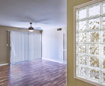 Spacious Living room with a sliding glass door and plank flooring at The Viridian Apartments in Scottsdale, Arizona 85250
