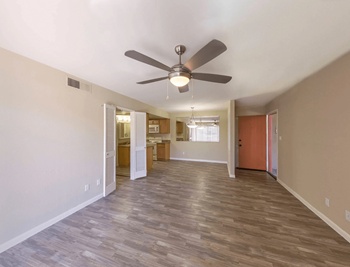 Living Room with Plank Flooring and Ceiling Fan at The Viridian Apartments in Scottsdale, AZ