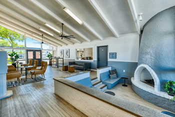 Resident lounge with modern design, an oversized enclosed fireplace with floor to ceiling windows at Connect on Missouri in Phoenix, AZ