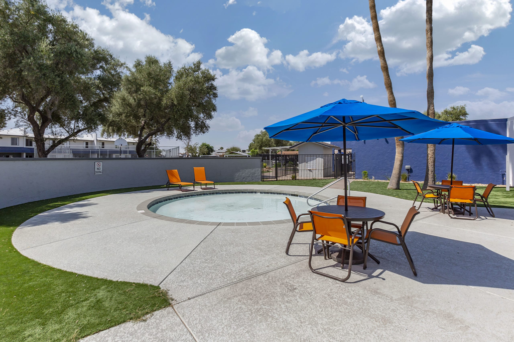 our apartments have a pool and patio with umbrellas