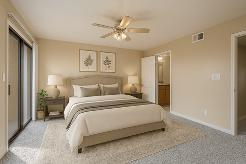 A bedroom with a large bed and a ceiling fan.