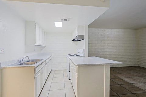 A kitchen with white cabinets and a white counter top.