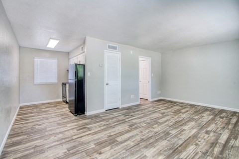 the living room of our studio apartment atrium with a refrigerator