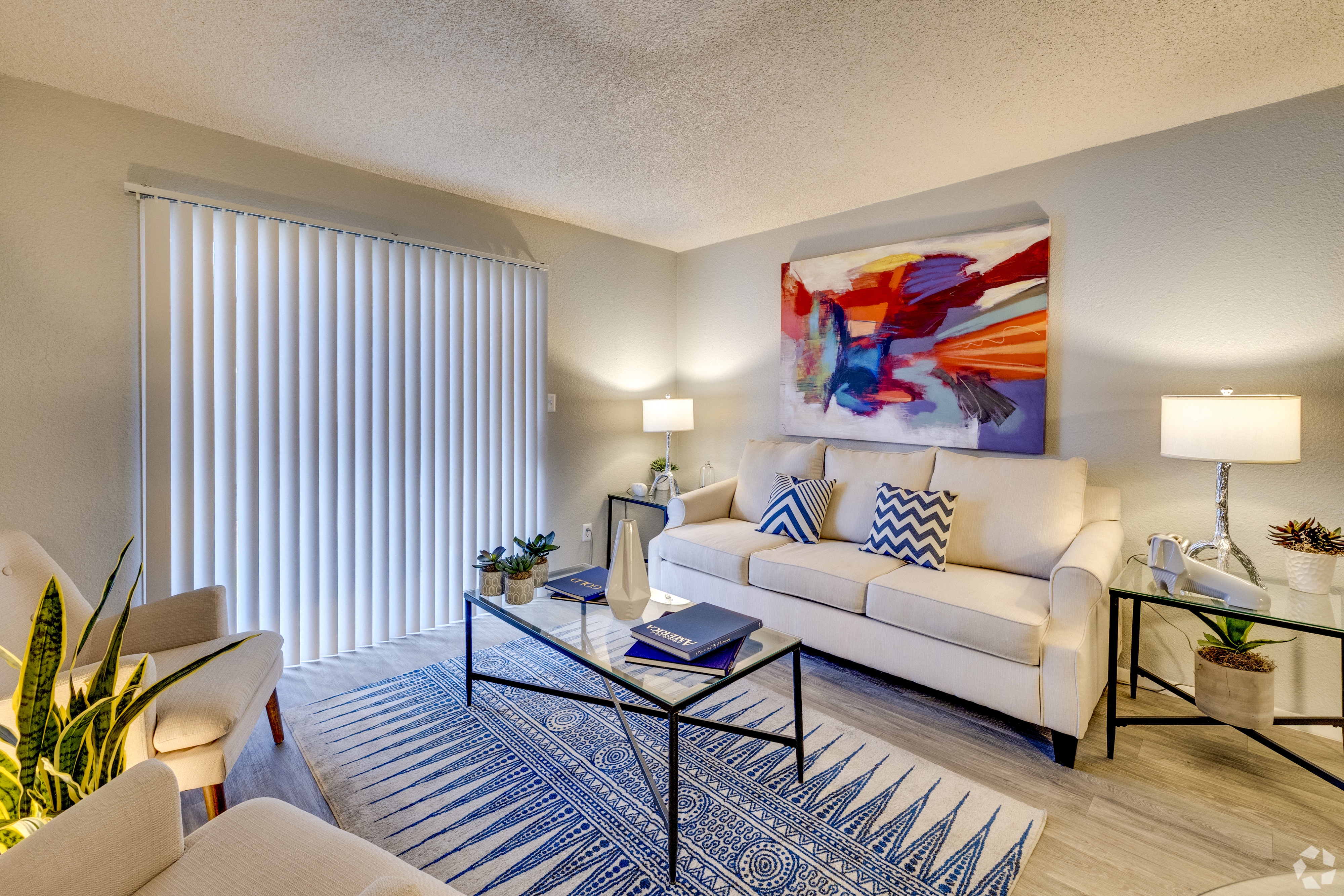a living room with a white couch and a coffee table