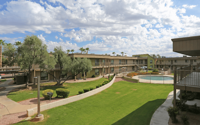 a view of the courtyard of an apartment building with a pool