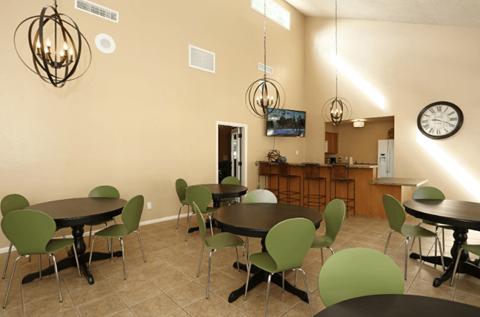 a dining room with tables and chairs and a clock on the wall