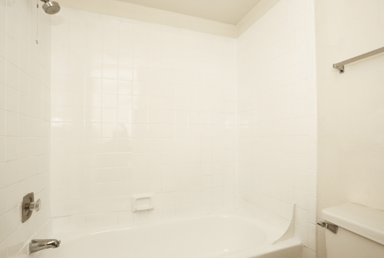 a white bathroom with a tub and a sink