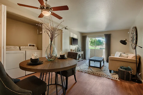 A living room with a brown table and a white sofa.