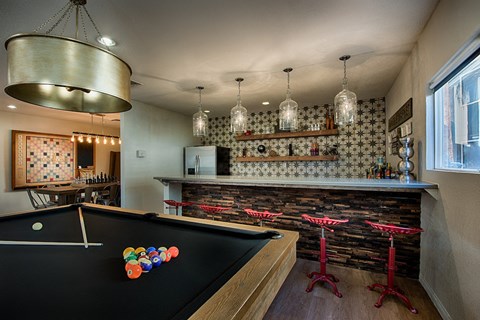 Game room with pool table and bar area at Tela Verde Apartment Homes, Glendale, AZ