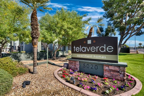 Monument sign with colorful flower bed at Tela Verde Apartment Homes, Glendale, AZ