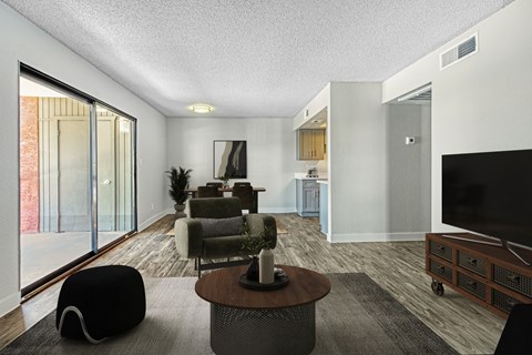 A modern living room with a black bean bag chair and a wooden coffee table.