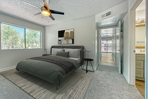Bedroom with ceiling fan and ensuite bathroom at Tela Verde Apartment Homes, Glendale, 85306