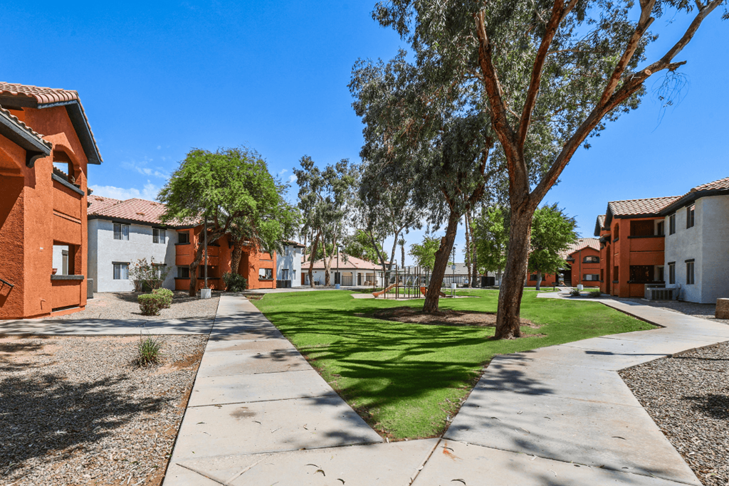 A sunny day in a residential area with houses and trees.