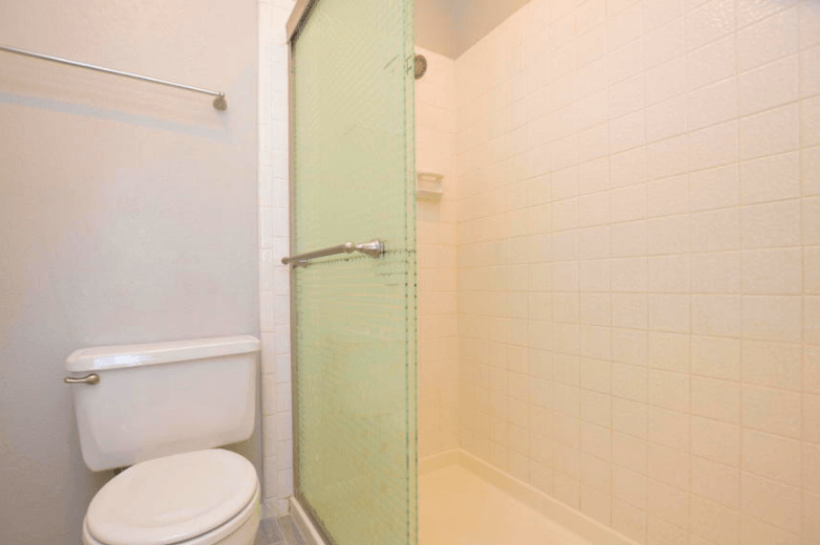 a bathroom with a toilet and a shower